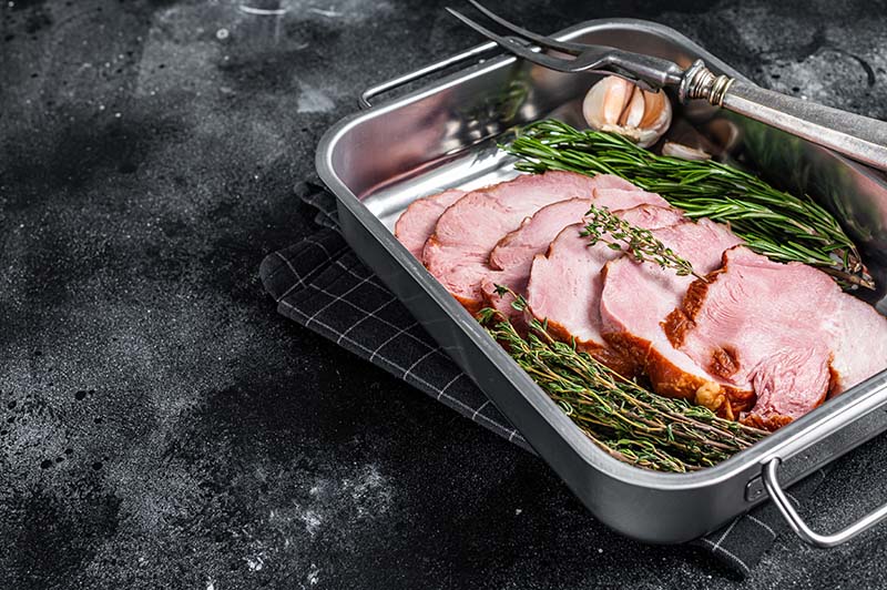cooked meat with fresh thyme and rosemary herbs